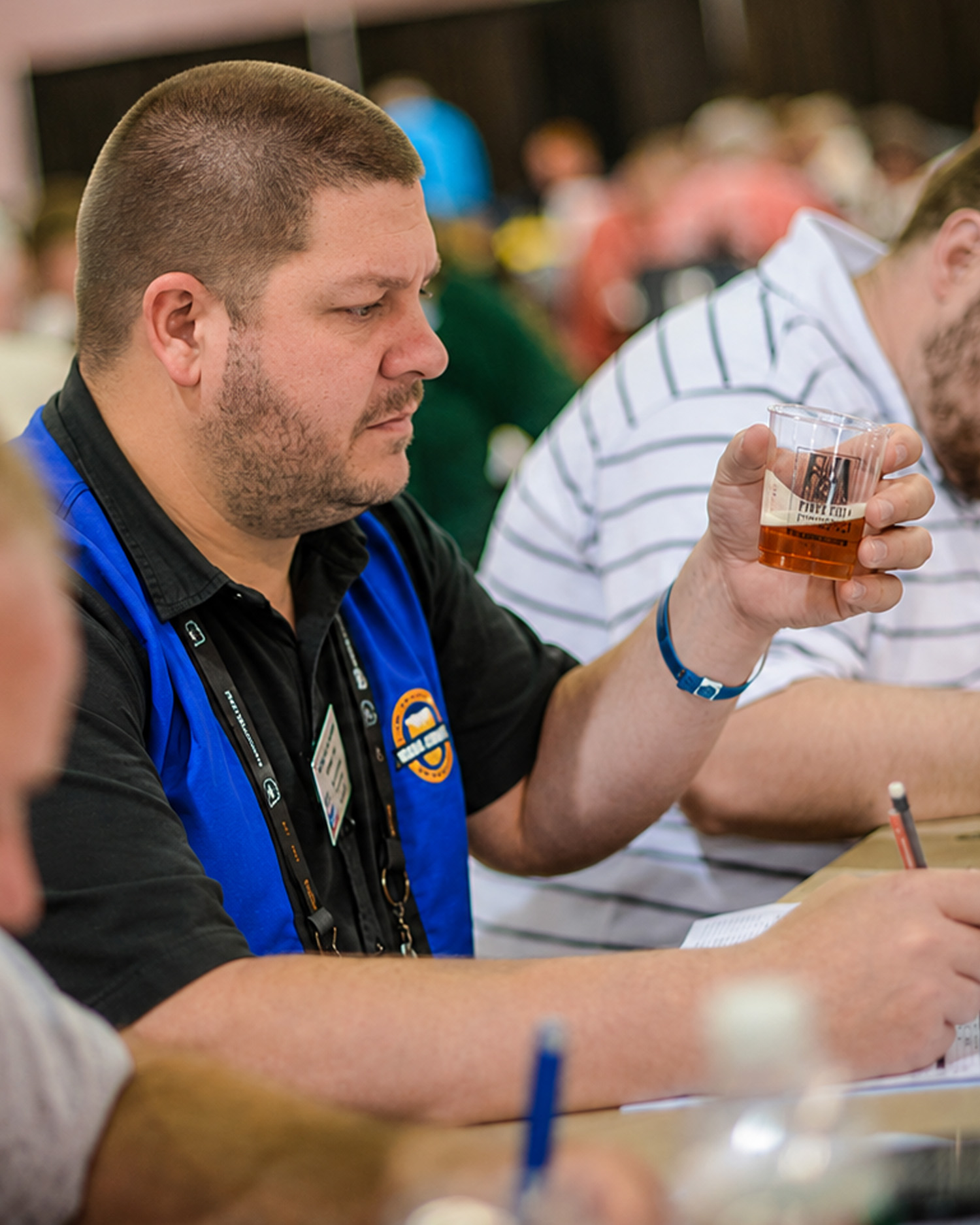 Gawain judging at a competition table - tasting and scoring beers alongside fellow judges